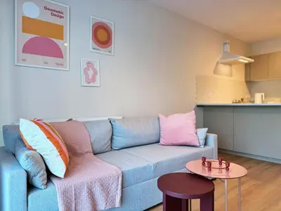 a living room with a blue couch and a table at Wieli Apartment in Wieliczka