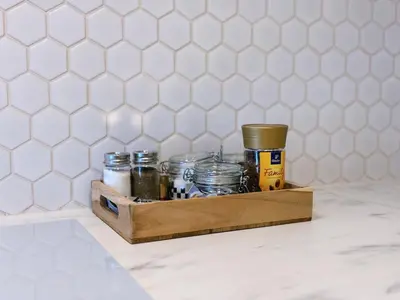a wooden box filled with jars on a counter at Wieli Apartment in Wieliczka