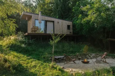 a small cabin in the middle of a forest at hOMM domek nad jeziorem in Stryszów