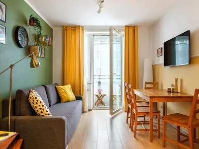 a living room with a couch and a table at Rewers apartment - Świętokrzyska St in Kraków