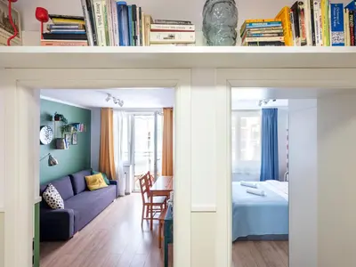 a living room and bedroom with a couch and a bed at Rewers apartment - Świętokrzyska St in Kraków
