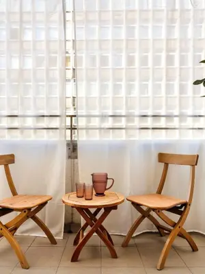 two chairs and a table in front of a window at Rewers apartment - Świętokrzyska St in Kraków