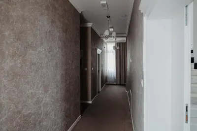 a hallway with brown walls and a long corridor at Pałac Lacon in Kazimierza Wielka