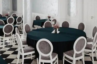 a conference room with green tables and chairs at Pałac Lacon in Kazimierza Wielka