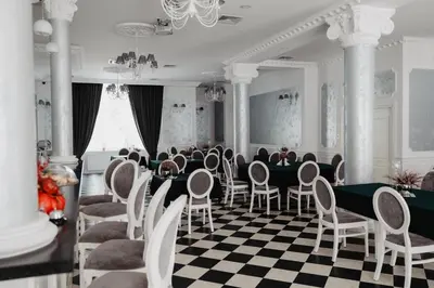 a dining room with a long table and chairs at Pałac Lacon in Kazimierza Wielka