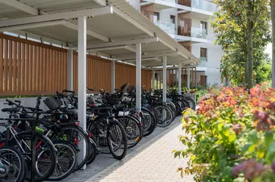 a row of bikes parked under a building at Malila Premium Apartments Cracow Tauron Arena Lema 15 in Kraków