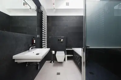 a bathroom with a sink and a toilet and a shower at Aparthotel Miodowa 25 in Kraków