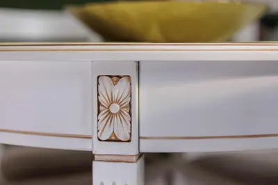 a white table with a drawer with a flower on it at Aparthotel Miodowa 25 in Kraków