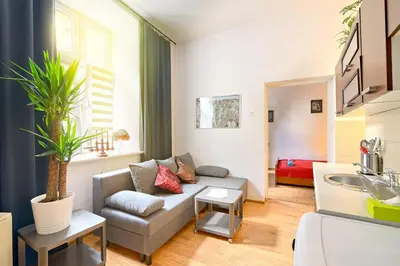 a living room with a couch and a sink at City Fever Apartment Kazimierz, WiFi in Kraków