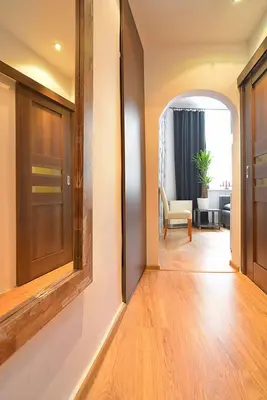 a hallway with a door and a chair in a room at City Fever Apartment Kazimierz, WiFi in Kraków