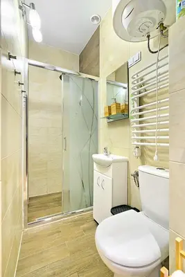 a bathroom with a toilet and a glass shower at City Fever Apartment Kazimierz, WiFi in Kraków
