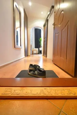 a pair of shoes sitting on a mat in front of a door at City Fever Apartment Kazimierz, WiFi in Kraków