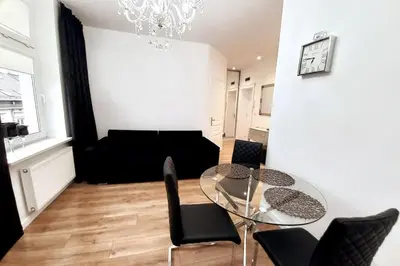 a living room with a glass table and chairs at Old Town - Traugutta Street flat 9 in Kraków