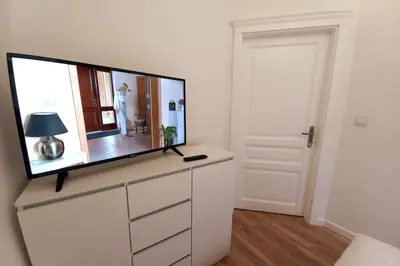 a flat screen tv sitting on top of a dresser at Old Town - Traugutta Street flat 9 in Kraków