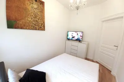 a bedroom with a bed and a tv on a dresser at Old Town - Traugutta Street flat 9 in Kraków