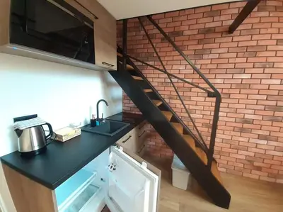 a staircase in a kitchen with a brick wall at Loft Apartment Old Town - G46 in Kraków