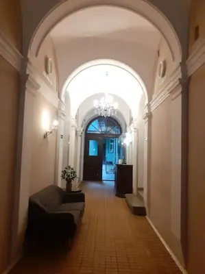 a hallway with an archway with a couch in a building at Loft Apartment Old Town - G46 in Kraków
