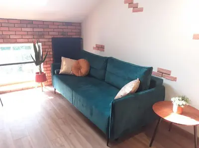 a living room with a blue couch and a table at Loft Apartment Old Town - G46 in Kraków
