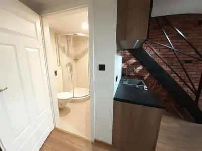 a bathroom with a staircase with a toilet and a sink at Loft Apartment Old Town - G46 in Kraków