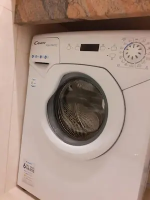a washing machine with its door open in a room at Loft Apartment Old Town - G46 in Kraków