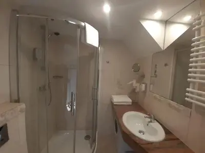 a bathroom with a glass shower and a sink at Loft Apartment Old Town - G46 in Kraków