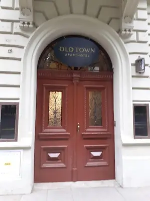 a red door of a building with a sign above it at Loft Apartment Old Town - G46 in Kraków