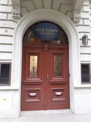 a red door of a building with a sign above it at Loft Apartment Old Town - G47 in Kraków