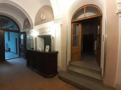 a hallway of a building with a desk and a door at Loft Apartment Old Town - G47 in Kraków