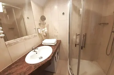 a bathroom with a sink and a shower at Loft Apartment Old Town - G47 in Kraków