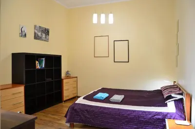 a bedroom with a bed and a dresser at Caffe Latte, City Center Apartment in Kraków