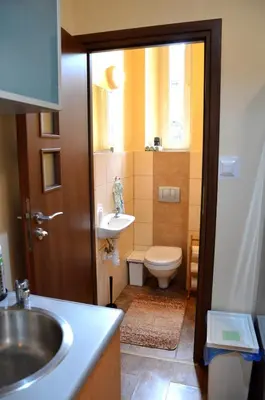 a bathroom with a sink and a toilet at Caffe Latte, City Center Apartment in Kraków