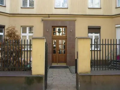 an entrance to a building with a wooden door at Caffe Latte, City Center Apartment in Kraków
