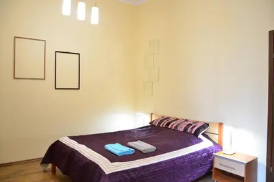 a bedroom with a bed with two towels on it at Caffe Latte, City Center Apartment in Kraków