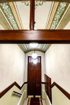 a hallway with a coffered ceiling and a wooden door at Air-conditioned attic apartment Old Town Main Railway Station in Kraków