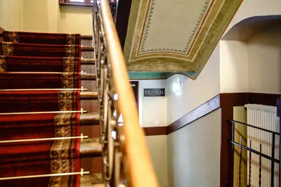 a set of stairs with a picture on the wall at Air-conditioned attic apartment Old Town Main Railway Station in Kraków
