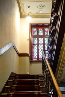 a staircase in a building with a window at Air-conditioned attic apartment Old Town Main Railway Station in Kraków