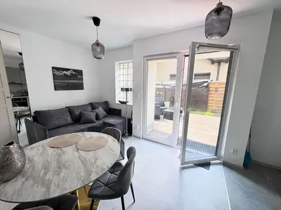 a living room with a table and a couch at Apartamenty na Wodzienowskiego in Kraków
