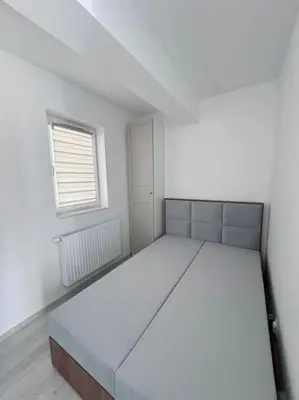 a white room with a large bed in it at Apartamenty na Wodzienowskiego in Kraków