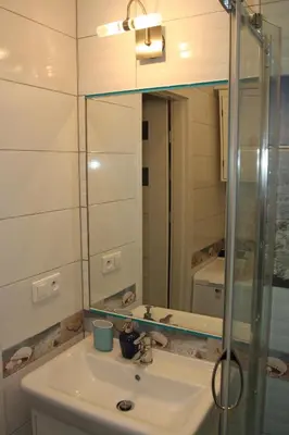 a bathroom with a sink and a mirror at Blue Traveler AC Apartment in Kazimierz in Kraków