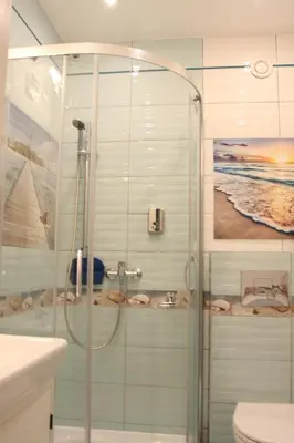 a bathroom with a shower and a toilet and a sink at Blue Traveler AC Apartment in Kazimierz in Kraków