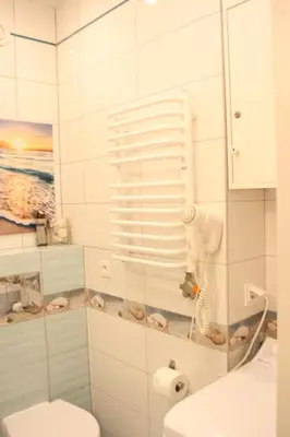 a bathroom with a toilet and a glass shower at Blue Traveler AC Apartment in Kazimierz in Kraków