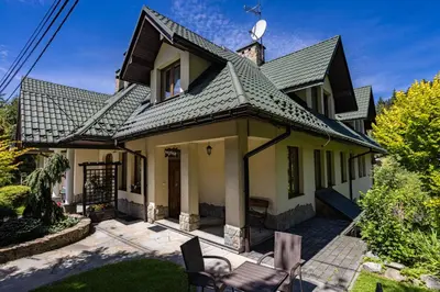 a house with a gray roof at Pensjonat Pod Długą Polaną in Nowy Targ