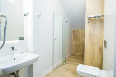 a bathroom with a sink and a toilet and a shower at Hotel nad Rabą - Bochnia in Bochnia