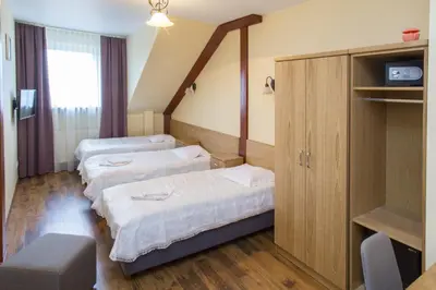 a hospital room with three beds in it at Hotel nad Rabą - Bochnia in Bochnia