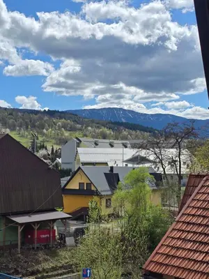 a town with houses and mountains in the background at Willa Babia Góra in Zawoja