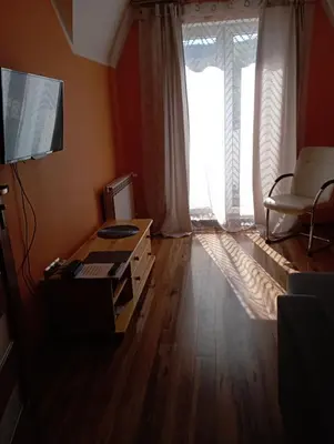 a living room with a table and a large window at Willa Babia Góra in Zawoja