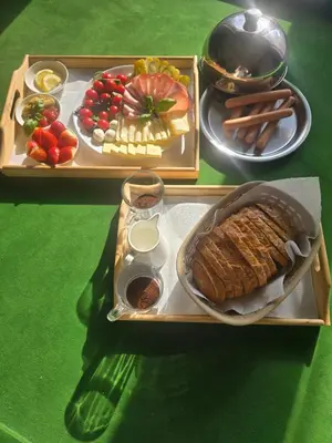 a tray of food with meat and fruit on a table at Willa Babia Góra in Zawoja