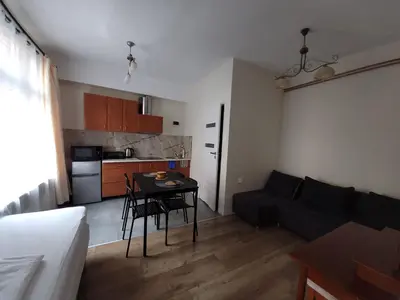 a small living room with a table and a couch at KĄCIK Apartament in Kraków