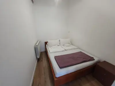 a small bedroom with a small bed in a room at KĄCIK Apartament in Kraków