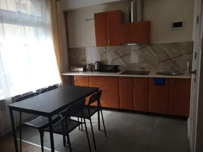 a small kitchen with a table and chairs in it at KĄCIK Apartament in Kraków